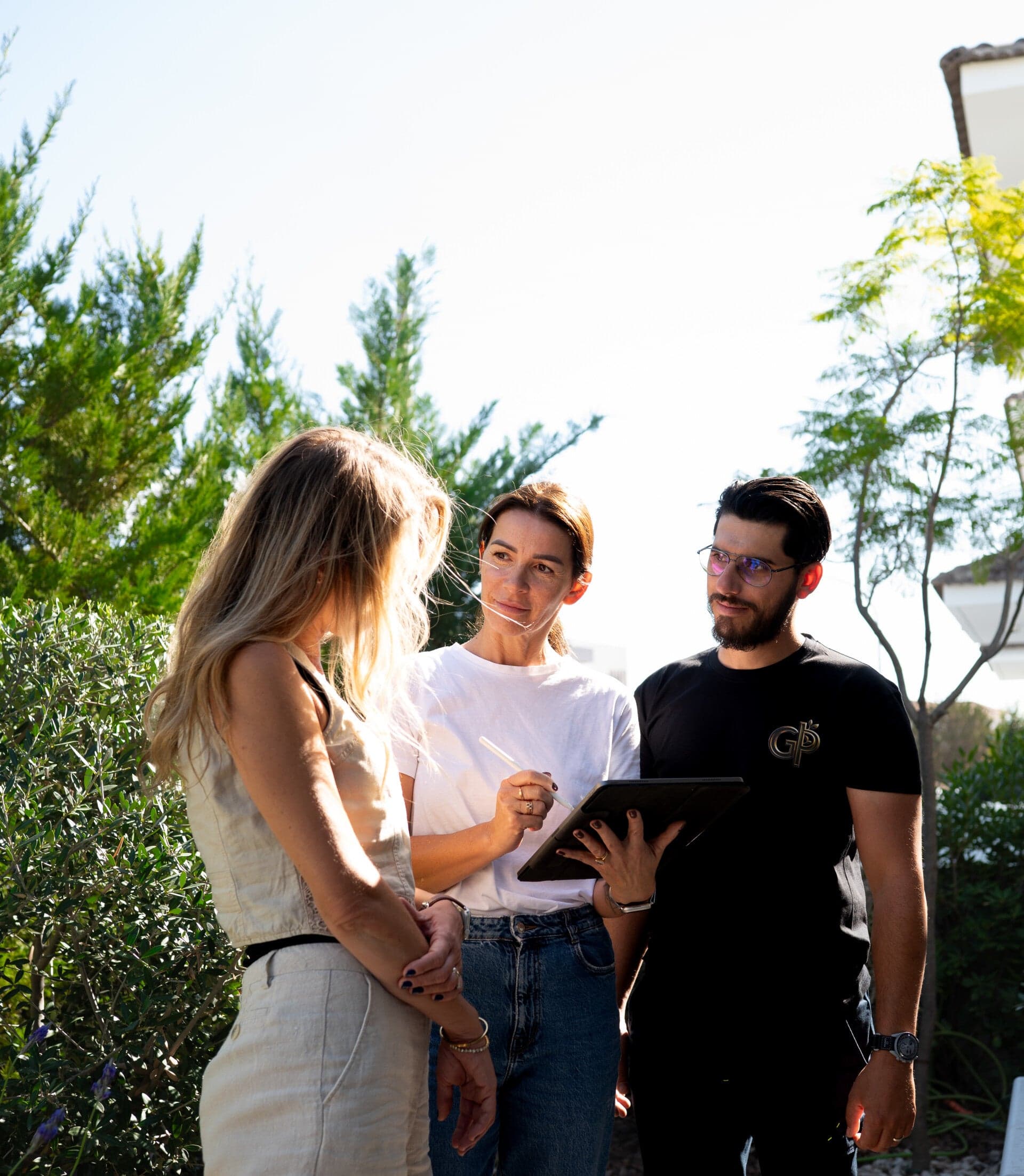 Green Planet Gardening consulting with clients, offering luxury garden design expertise and personalised outdoor planning.